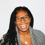 woman wearing glasses. she is smiling