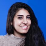 young woman with dark hair smiling