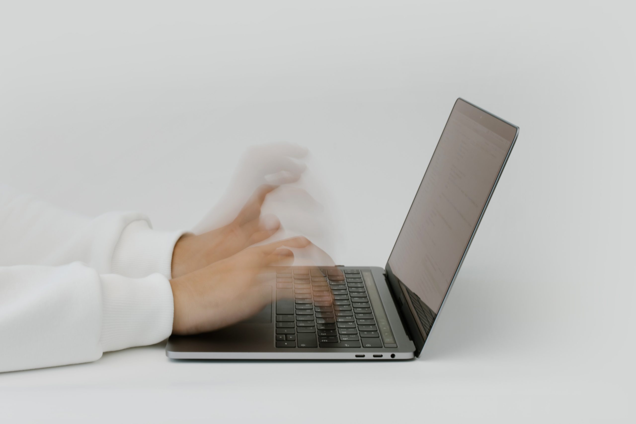hands typing over a keyboard