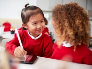 two young girls wearing school uniform