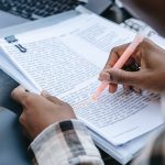 person highlighting a report pexels-photo-5965705